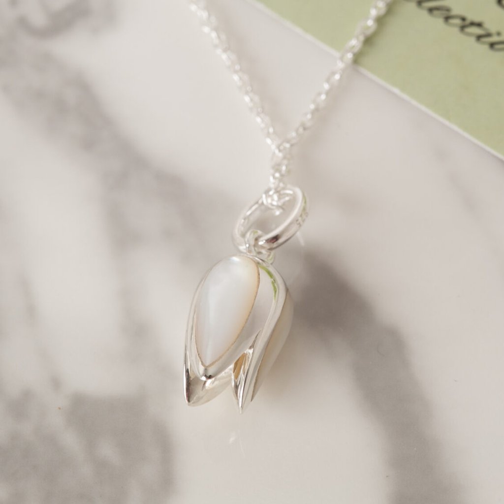 beautiful-tulip-pendant-hangs-from-sterling-silver-chain-on-marble-background