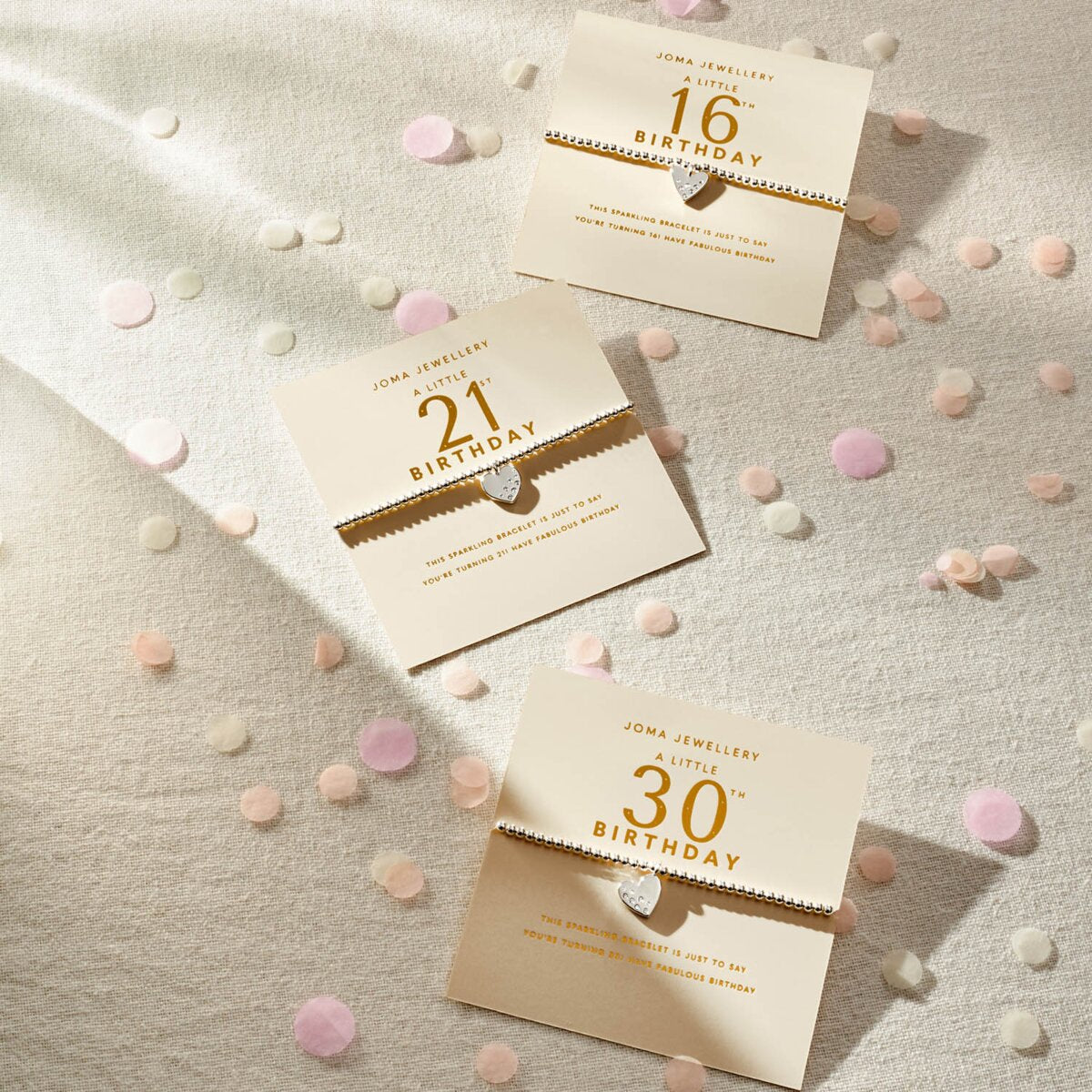 Three birthday invitations for 16, 21, and 30 years old on a textured surface with confetti.