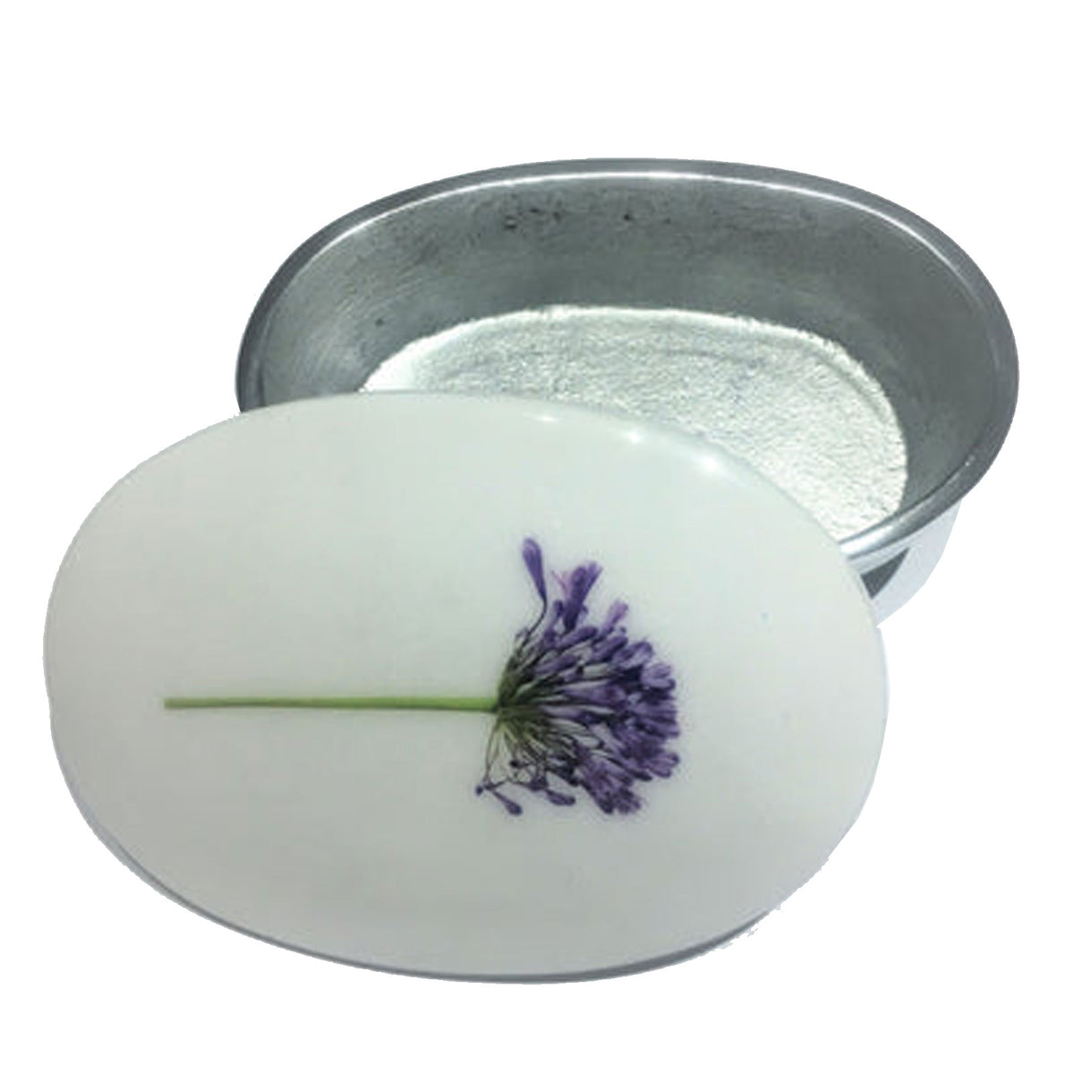 An oval white trinket box featuring a pressed purple flower, on a white background.