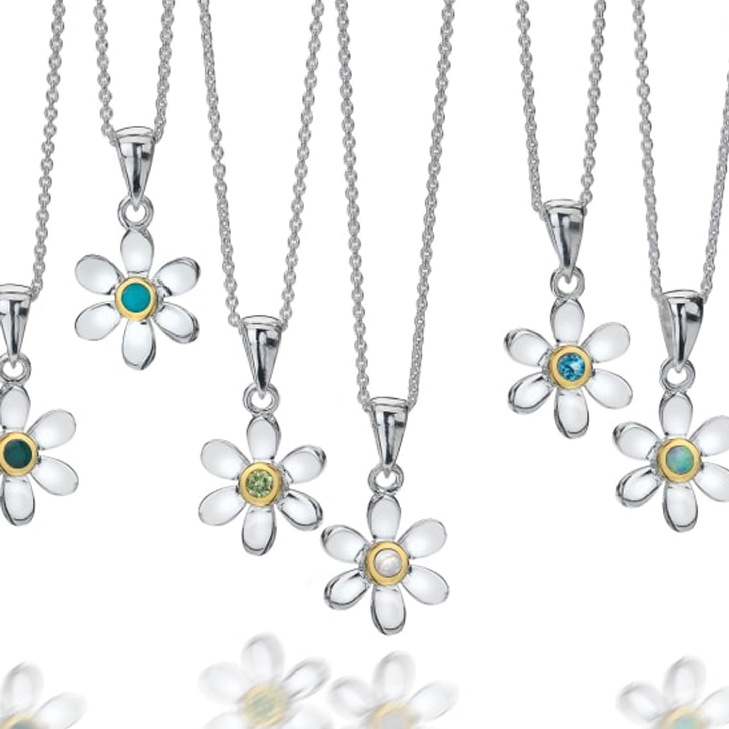 Silver flower-shaped pendants with gemstones on white background