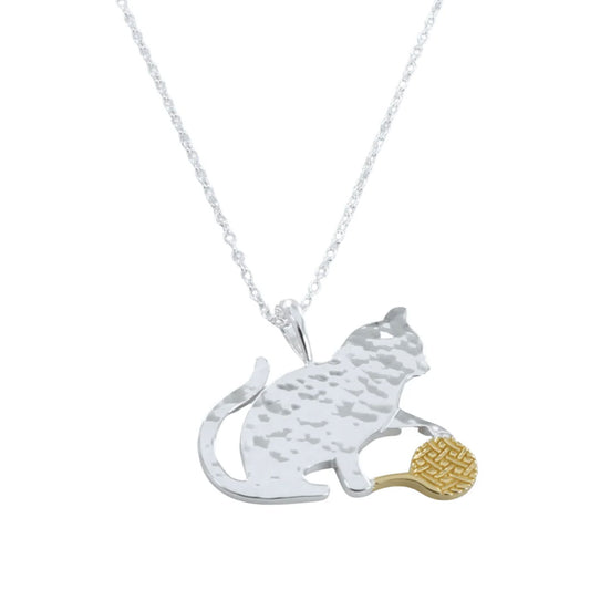 Silver necklace with a cat pendant holding a gold fish on a white background