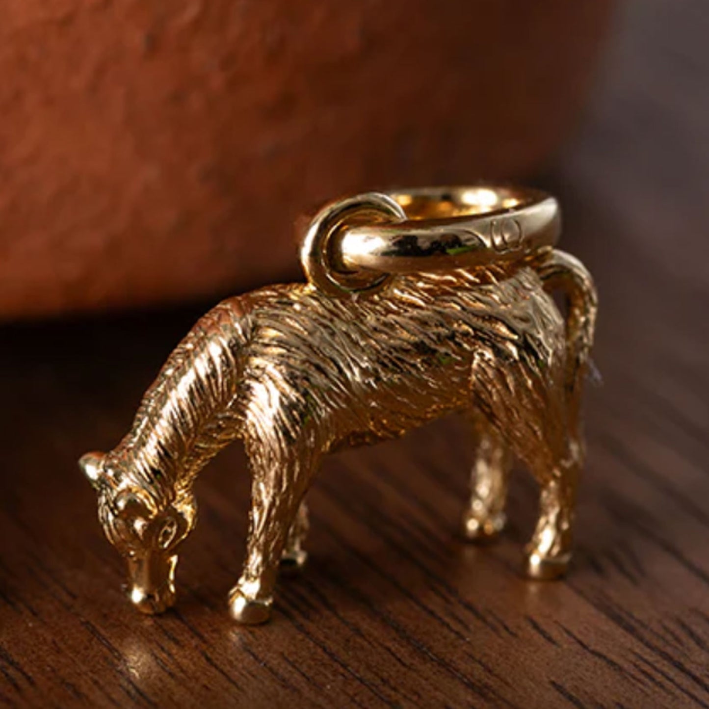 golden-pony-charm-on-wooden-side
