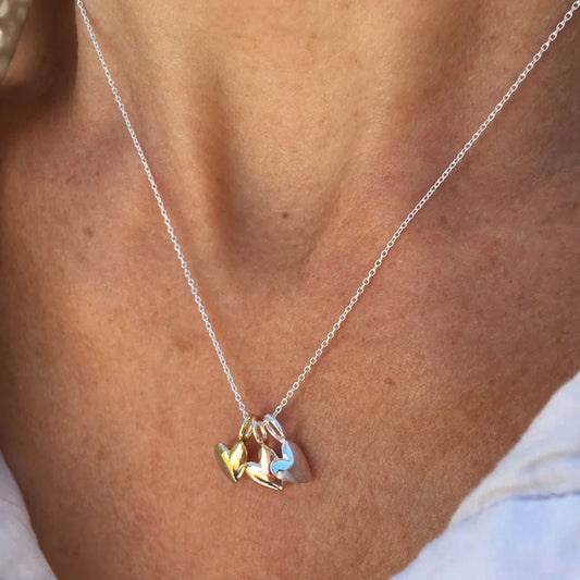 Silver necklace with a unique pendant on a person's neck