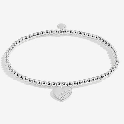 Silver beaded bracelet with a heart-shaped tag on a white background