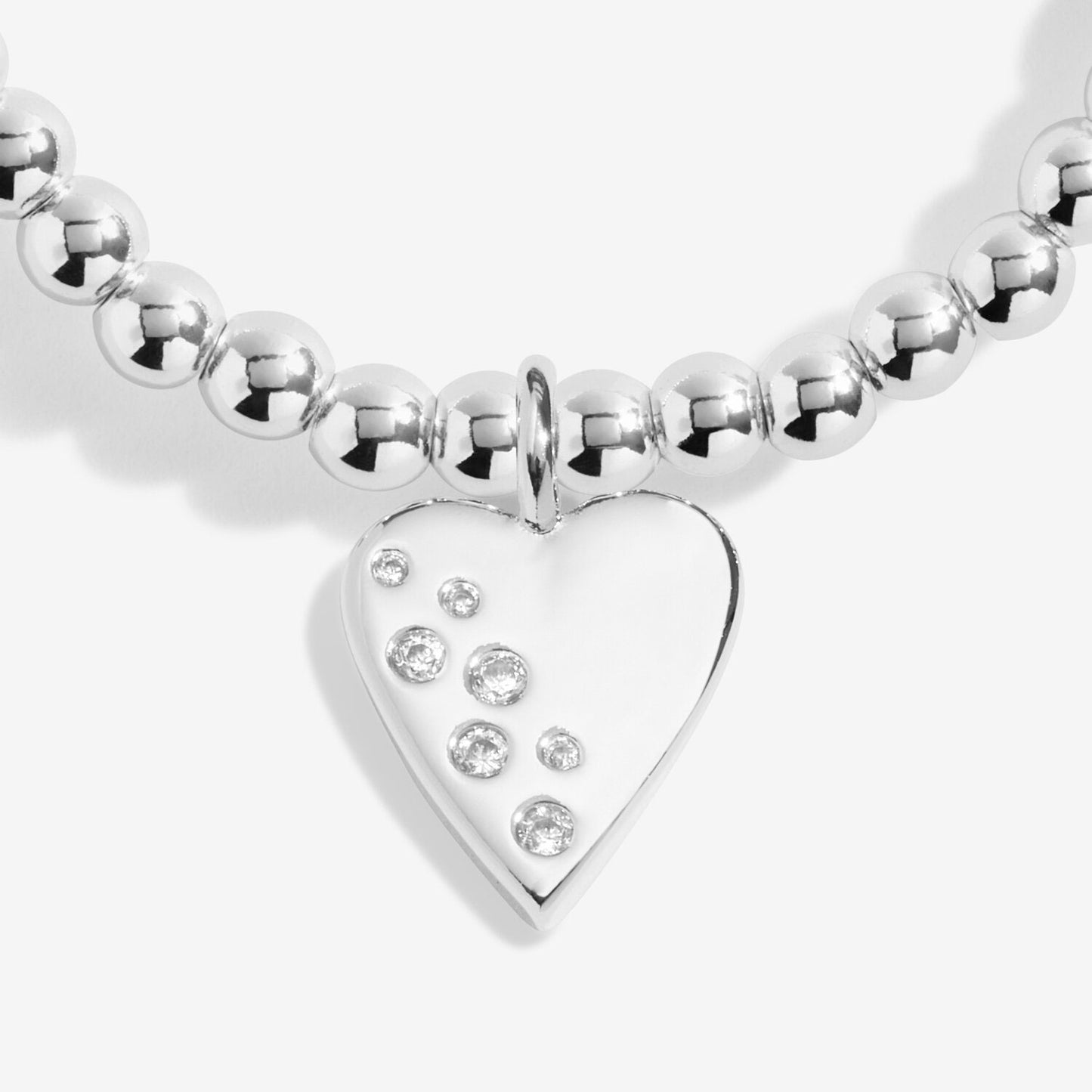 Silver beaded bracelet with a heart-shaped charm on a white background
