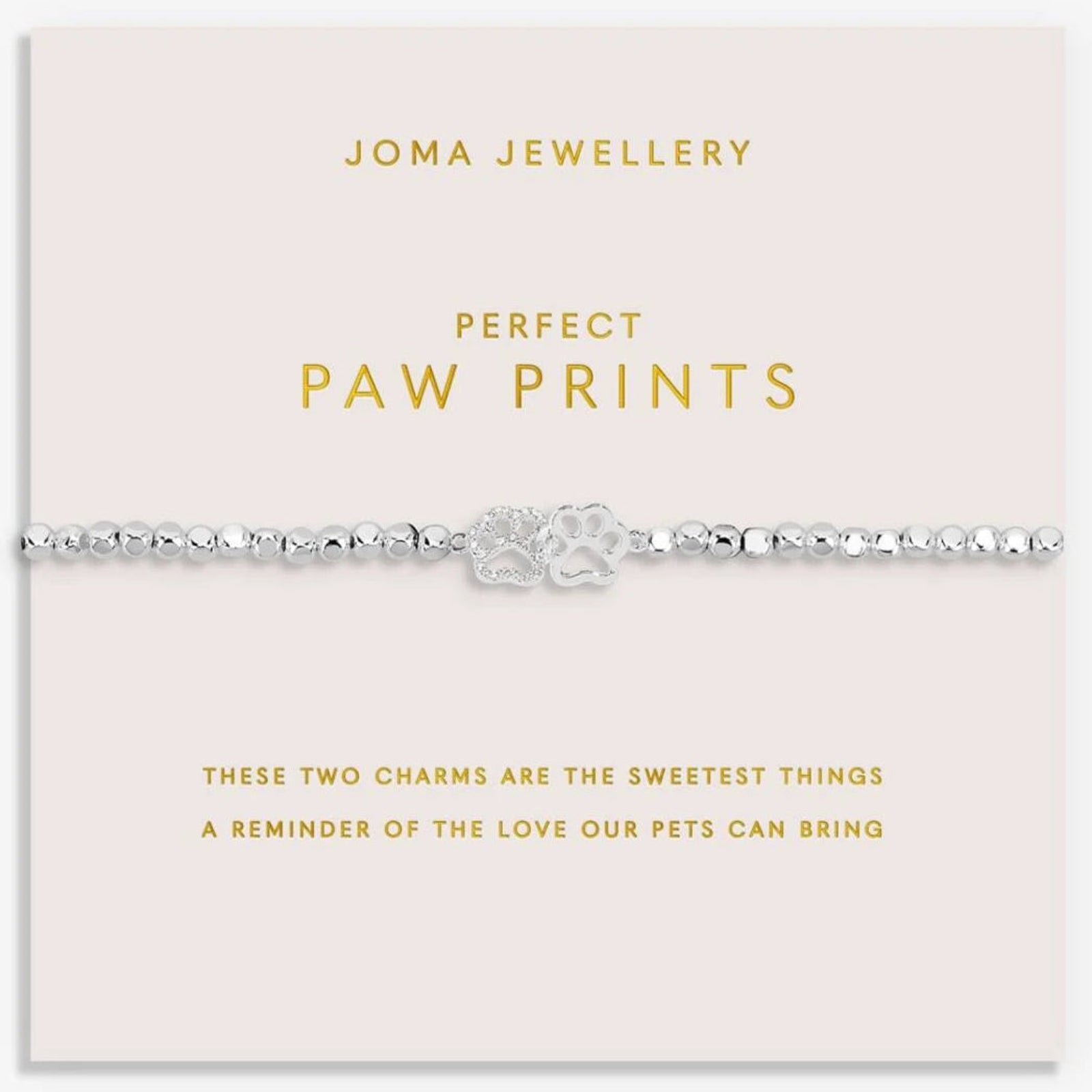 Joma Jewellery paw print bracelet on a pink card with gold text