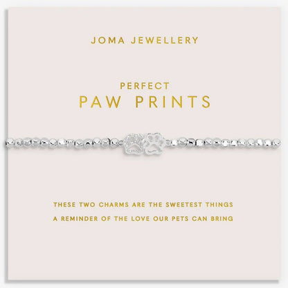 Joma Jewellery paw print bracelet on a pink card with gold text