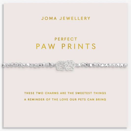 Joma Jewellery paw print bracelet on a pink card with gold text