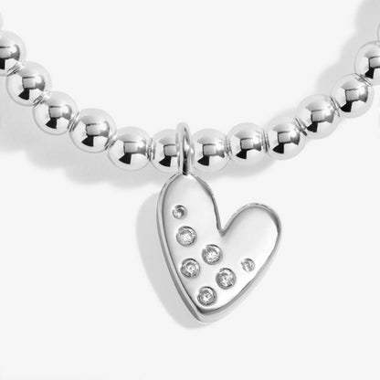 Silver beaded bracelet with a heart-shaped charm on a white background