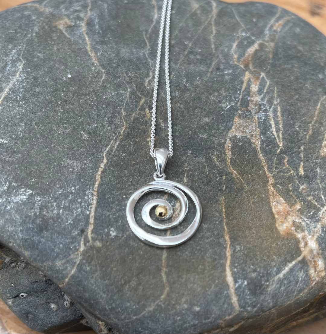 spiral-sterling-silver-necklace-on-stone