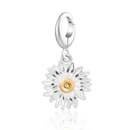 Silver daisy charm with a gold center on a white background