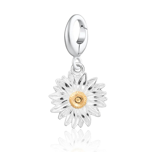 Silver daisy charm with a gold center on a white background