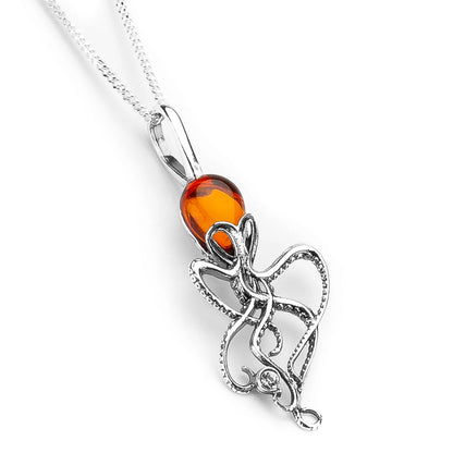 Silver octopus pendant with an amber gemstone on a white background