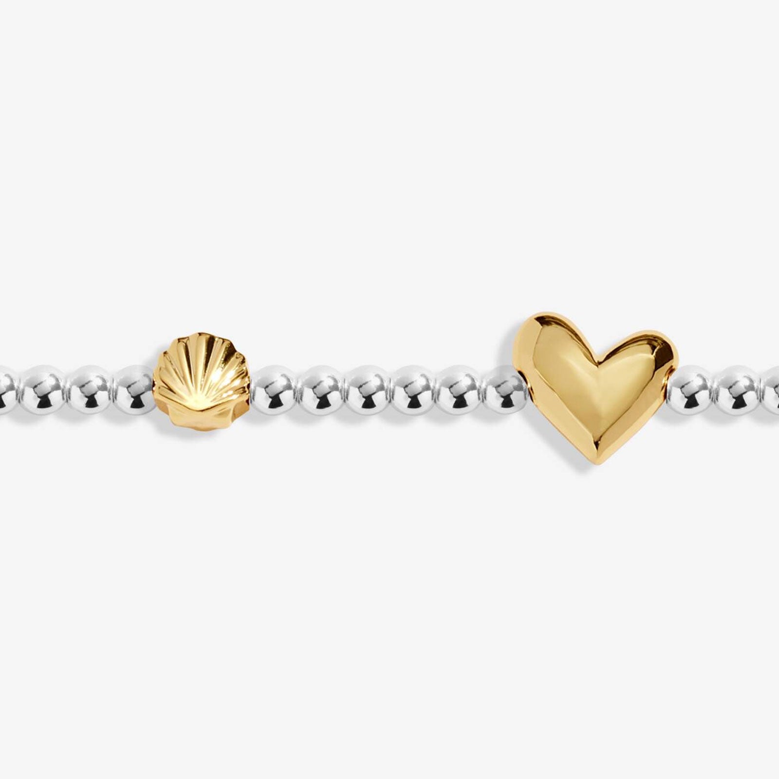 golden heart and shell charm on silver beaded bracelet
