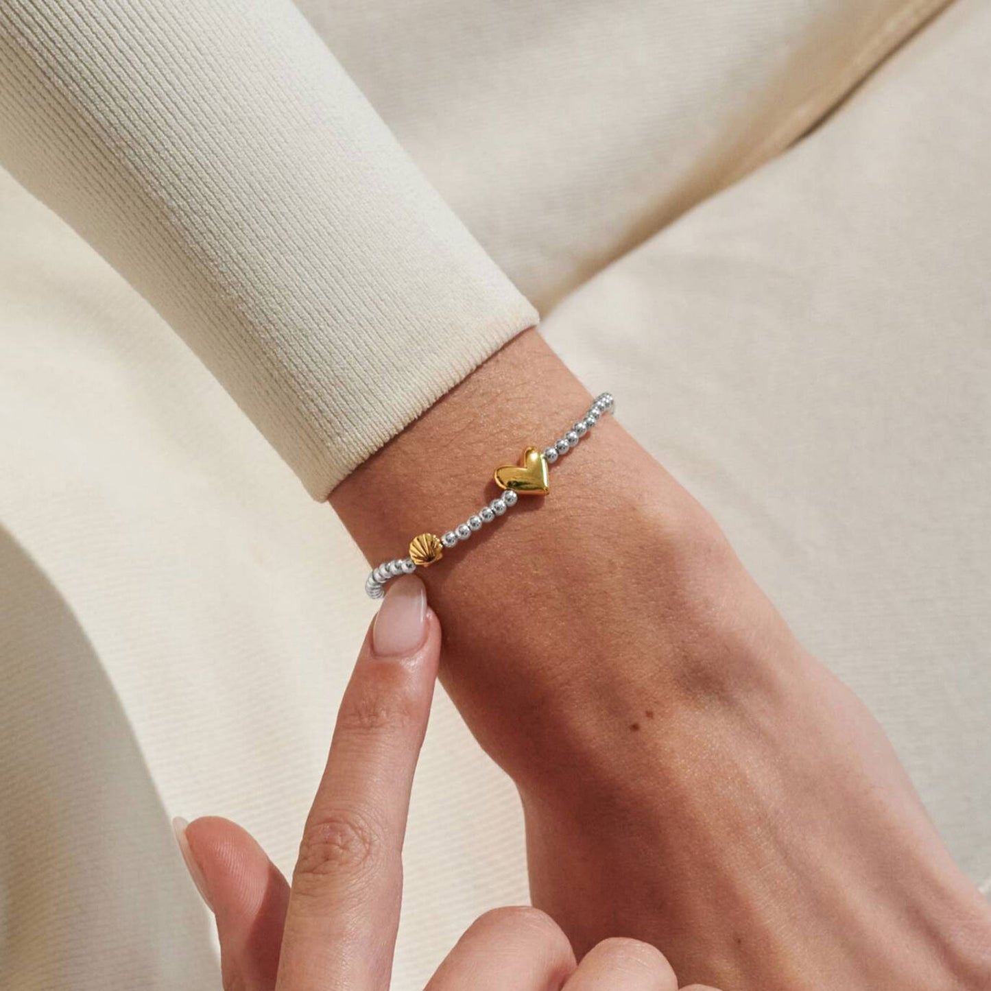 gold heart charm on arm