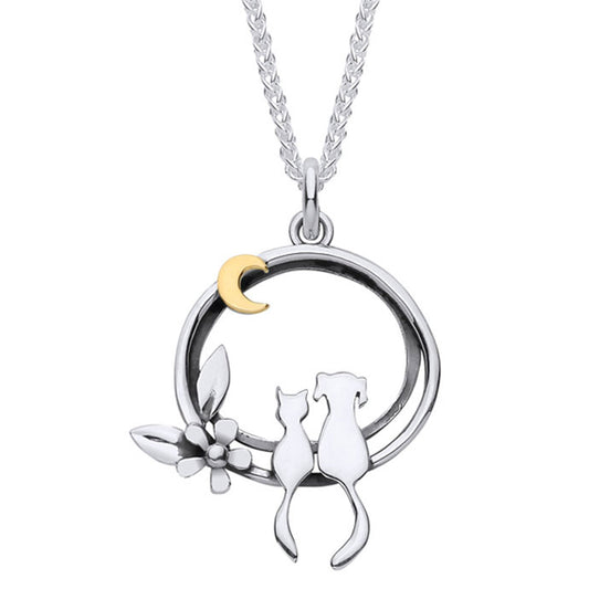 A silver pendant necklace featuring a circular design with cat and dog sitting together, a small white flower, a gold crescent moon, and a silver chain, shown on a plain white background.