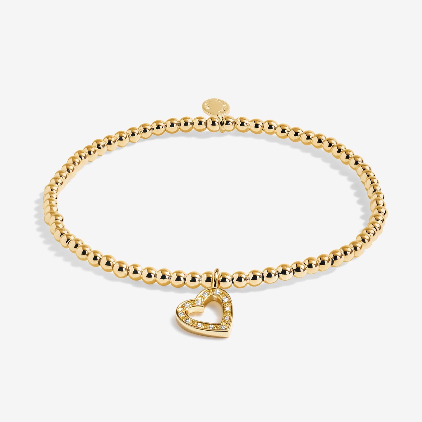 Gold bracelet with a heart-shaped charm on a white background