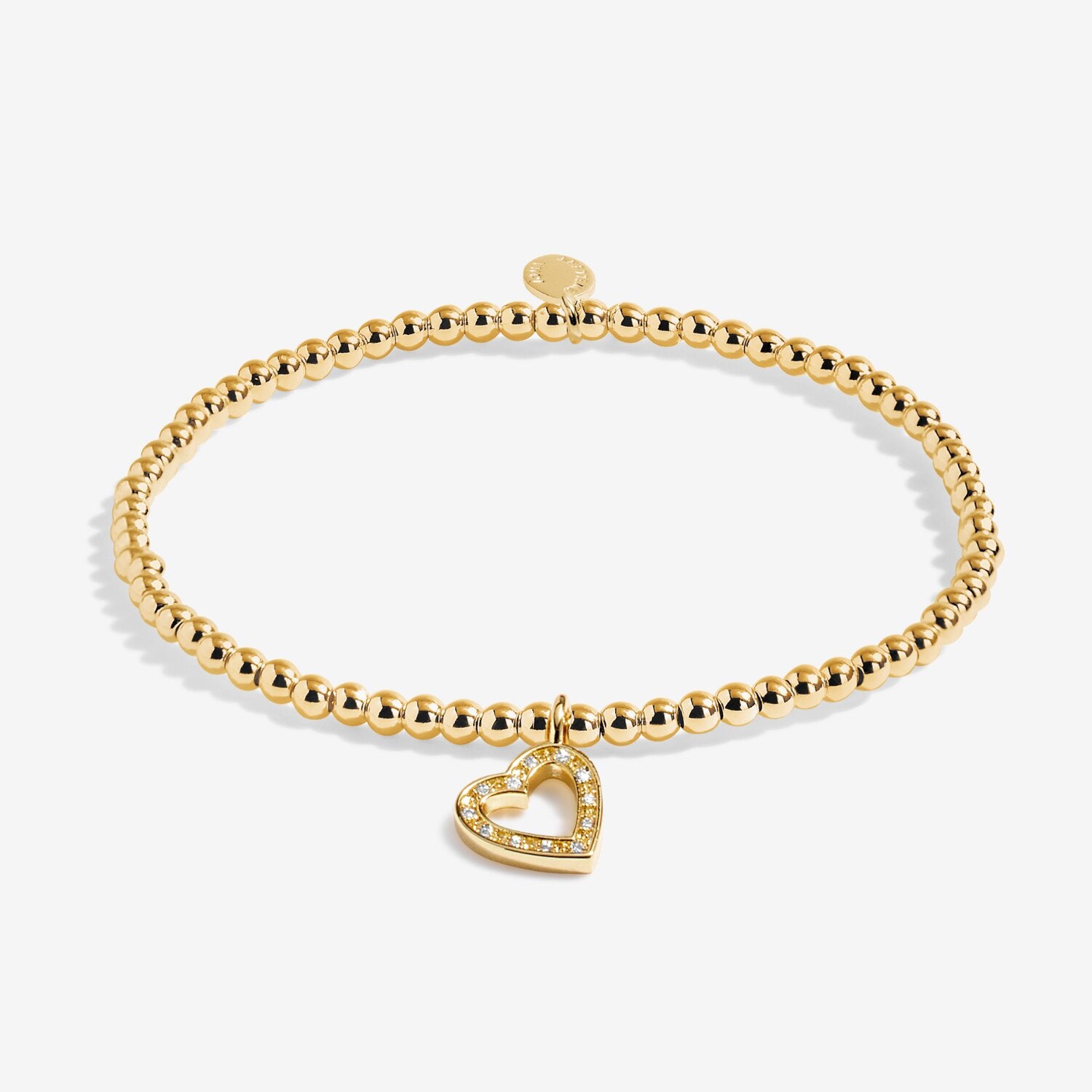 Gold bracelet with a heart-shaped charm on a white background