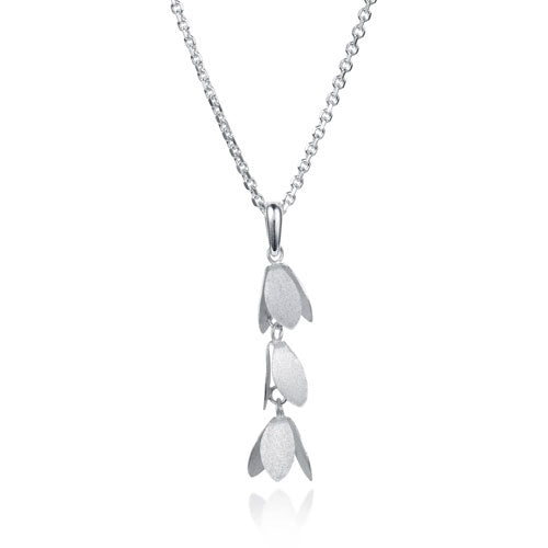 A silver pendant necklace featuring three vertically stacked, textured petal-like charms on a delicate chain, set against a plain white background with a soft reflection below.
