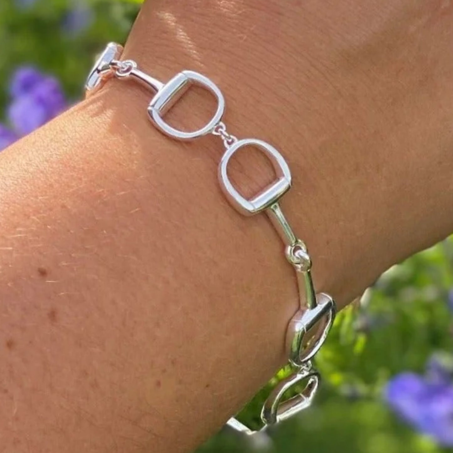 chunky silver snaffle bracelet on wrist 