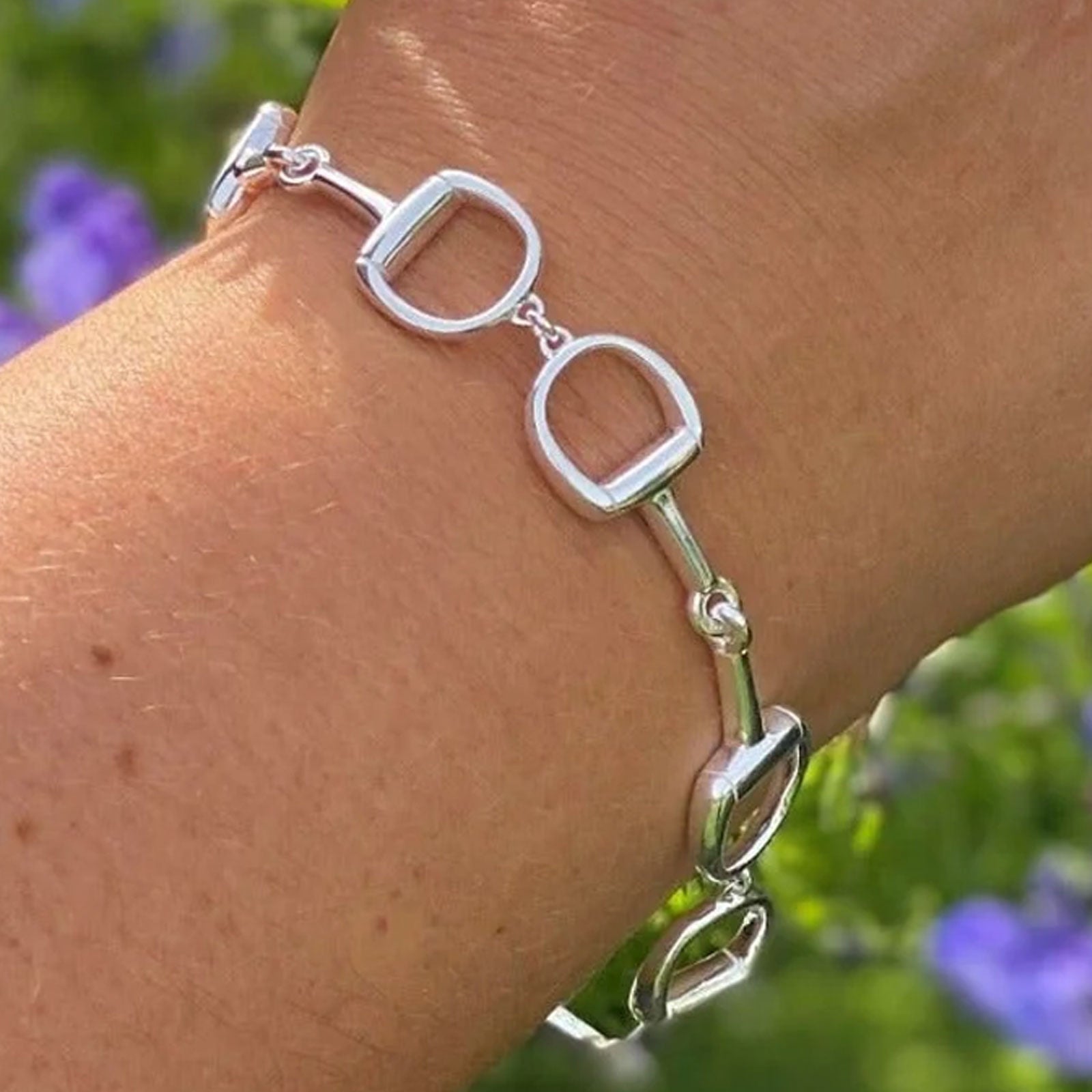 chunky silver snaffle bracelet on wrist 