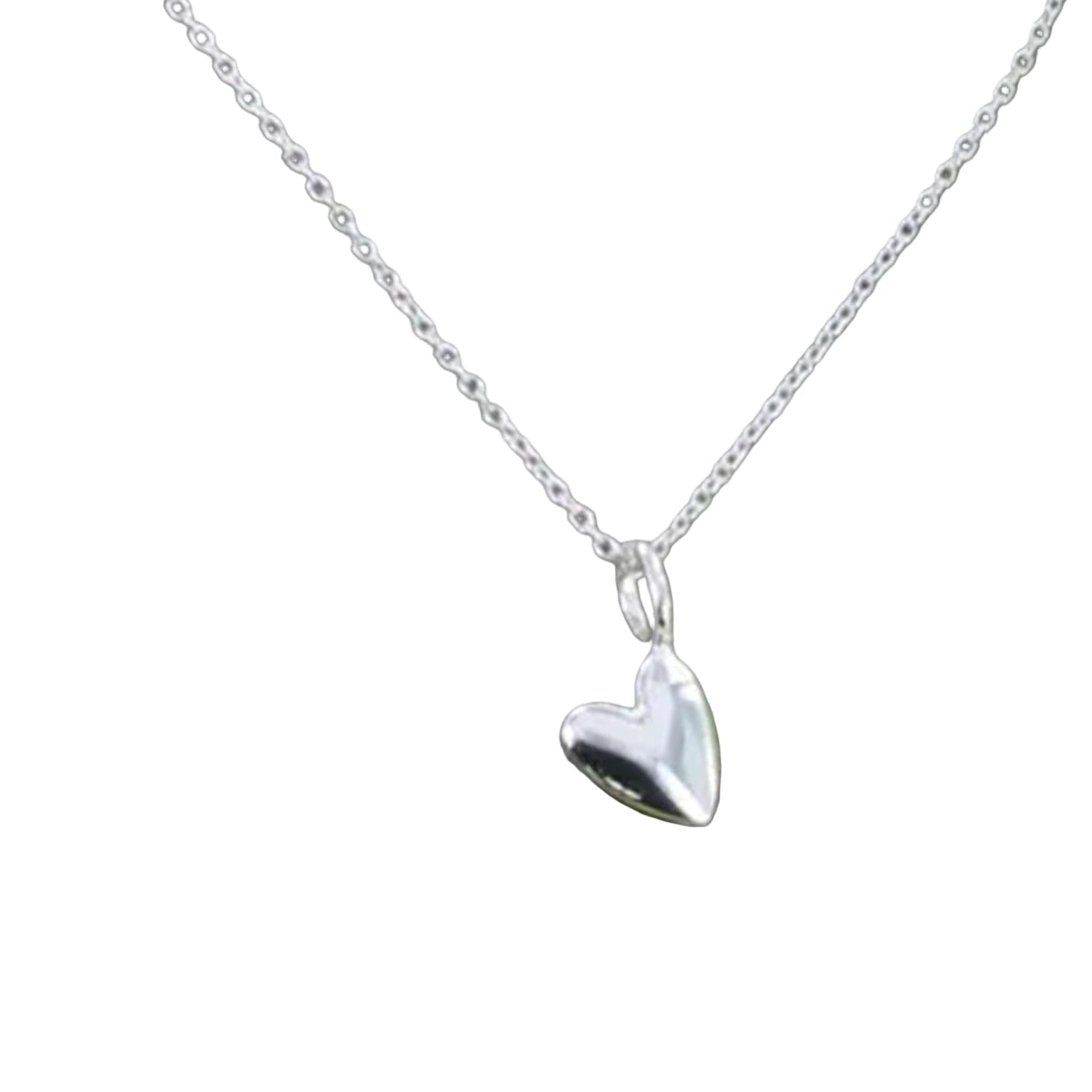 Silver heart-shaped pendant on a chain against a white background