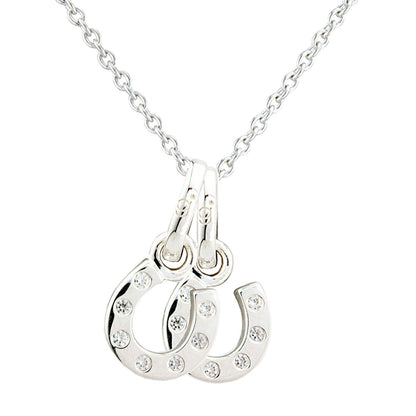 A silver-toned necklace featuring a double-horseshoe pendant embellished with small clear rhinestones, shown against a plain white background.