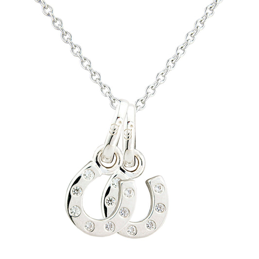 A silver-toned necklace featuring a double-horseshoe pendant embellished with small clear rhinestones, shown against a plain white background.