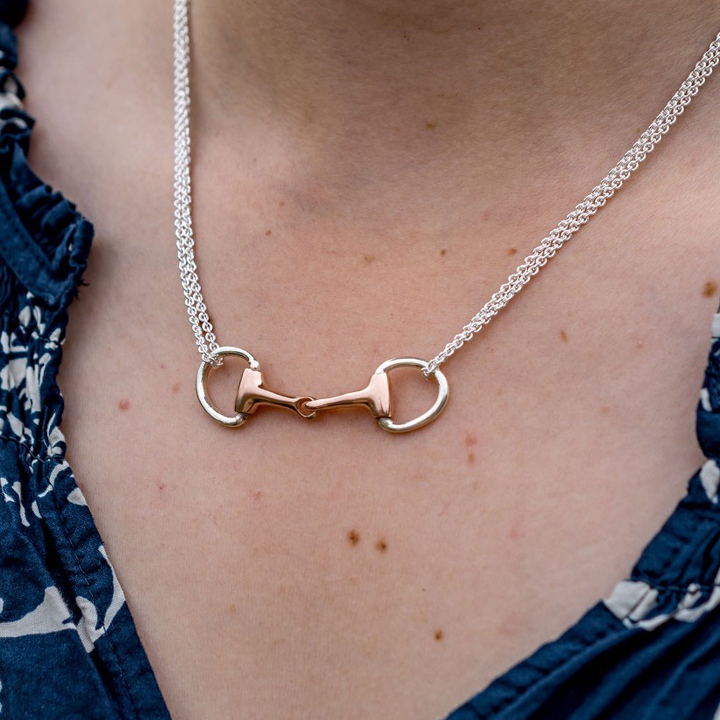 Necklace with a unique clasp design worn by a person