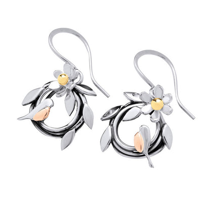 A pair of silver and rose gold dangle earrings featuring a stylized leafy wreath, a small flower, and a bird, shown on a plain white background.