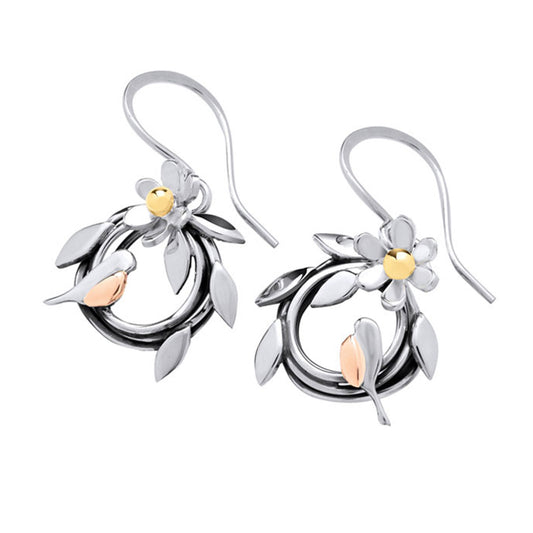 A pair of silver and rose gold dangle earrings featuring a stylized leafy wreath, a small flower, and a bird, shown on a plain white background.