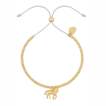 Gold beaded bracelet with a horse charm on a white background