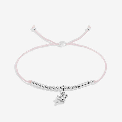 Silver bracelet with a pink cord on a white background