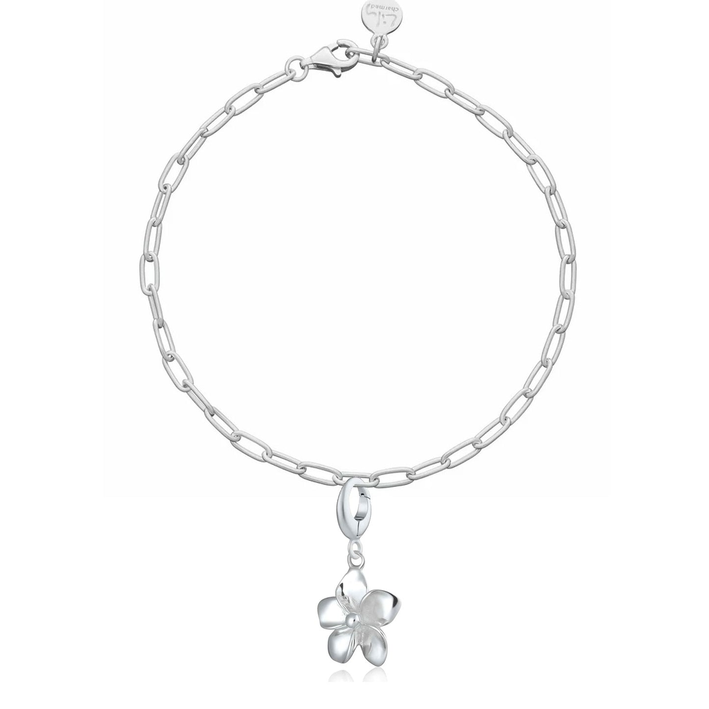 Silver chain bracelet with a flower-shaped charm on a white background