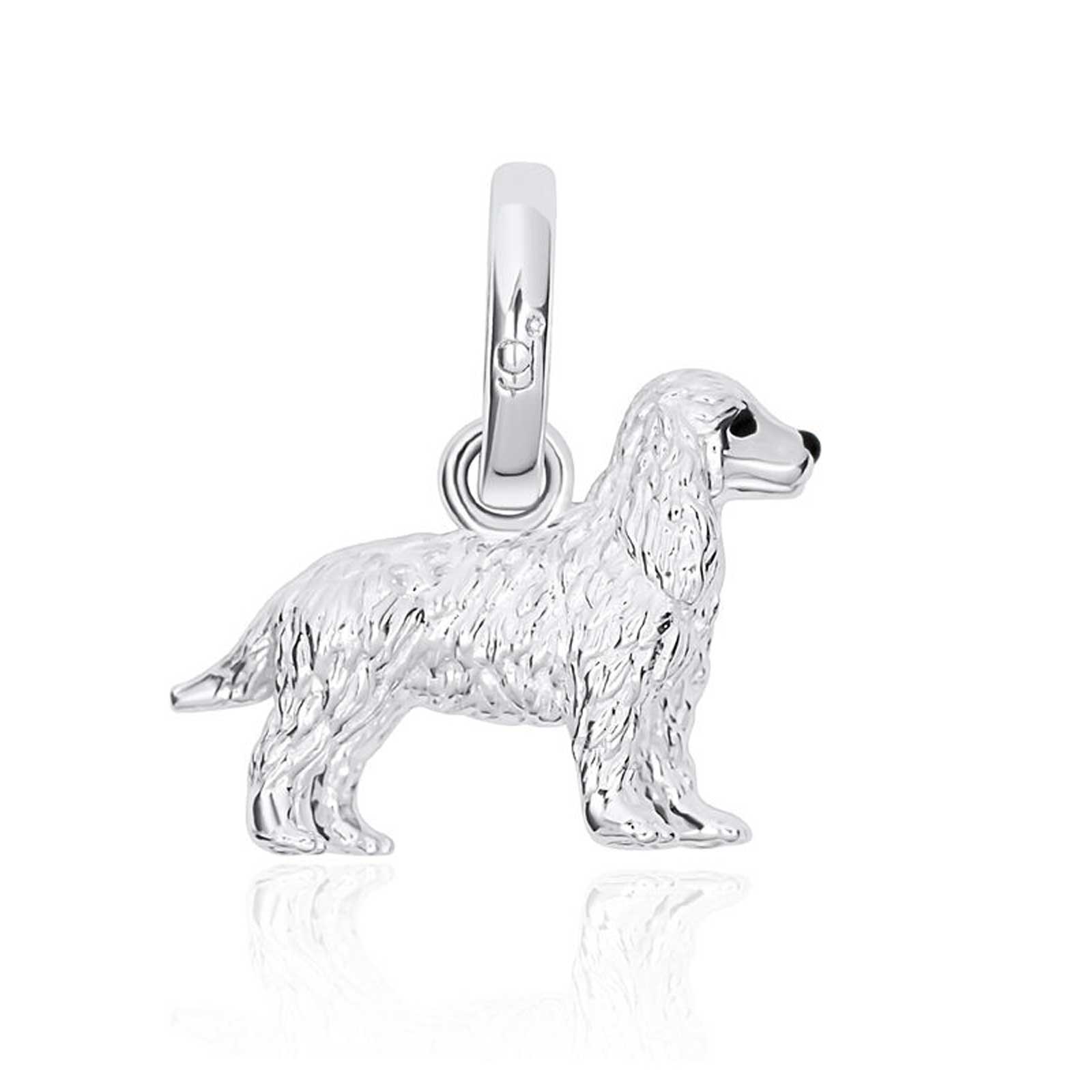 Silver dog charm on a white background