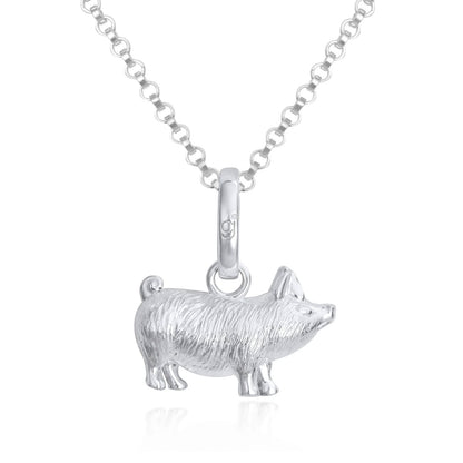 Silver pig pendant on a chain against a white background