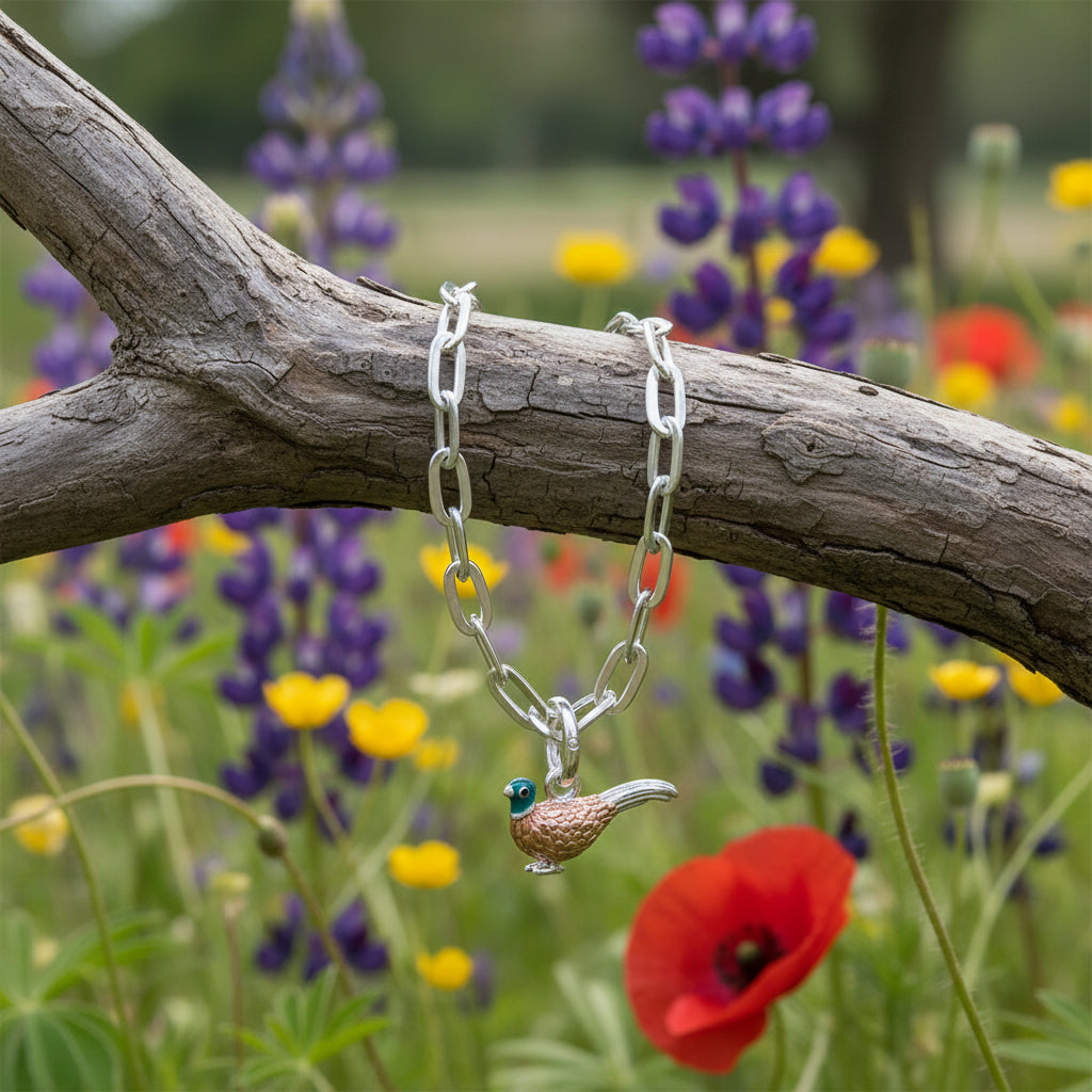 oval link bracelet with pheasant charm on white backgrond