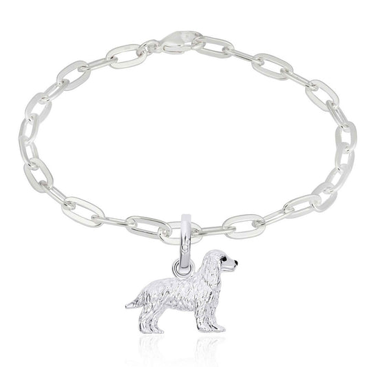 Silver chain bracelet with a dog charm on a white background