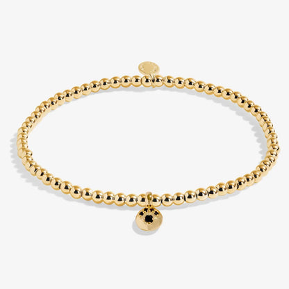 Gold beaded bracelet on a white background