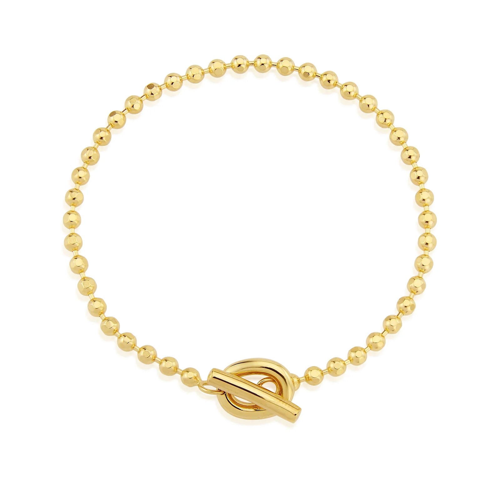 Gold beaded bracelet with a tbar clasp on a white background