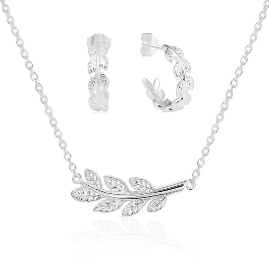 Silver laurel leaf branch necklace and matching laurel leaf hoop earrings, displayed on a clean white background with a soft reflection.