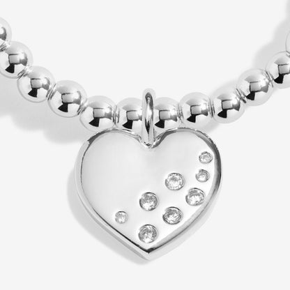 Silver beaded bracelet with a heart-shaped charm featuring embedded stones on a white background