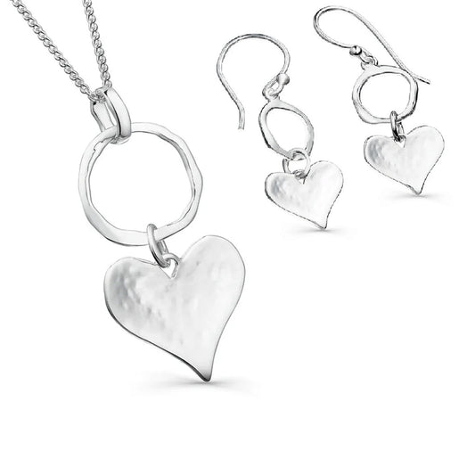 Silver heart-shaped jewelry set on a white background
