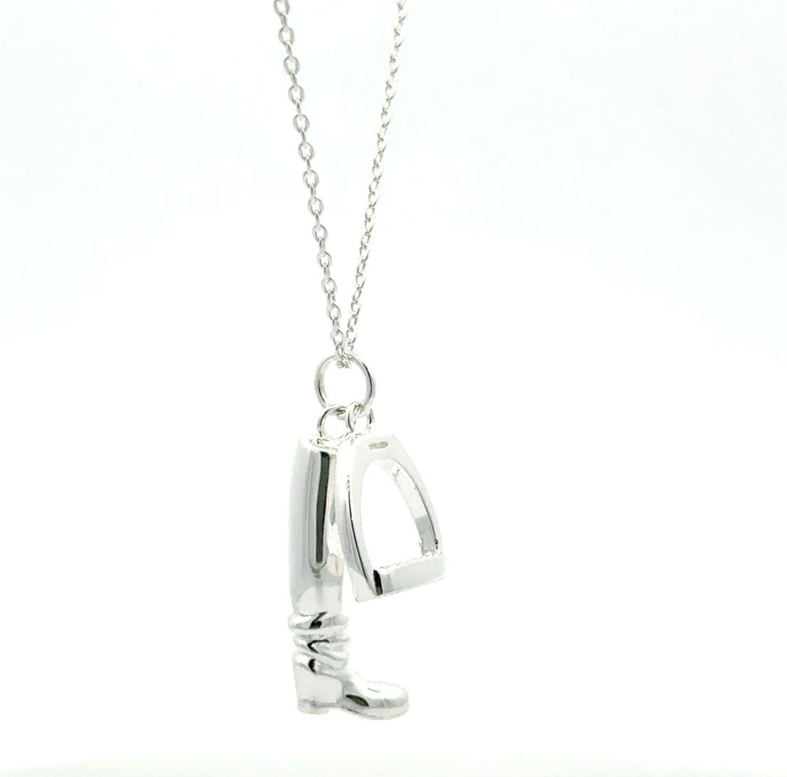 large boot and stirrup necklace with white background