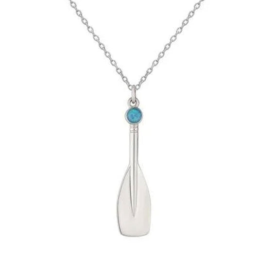 A silver pendant necklace shaped like an oar, featuring a small round turquoise-blue stone at the top, shown on a white background.