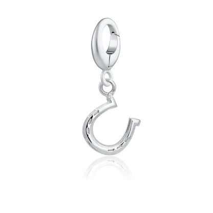 Silver charm with an equestrian design on a white background