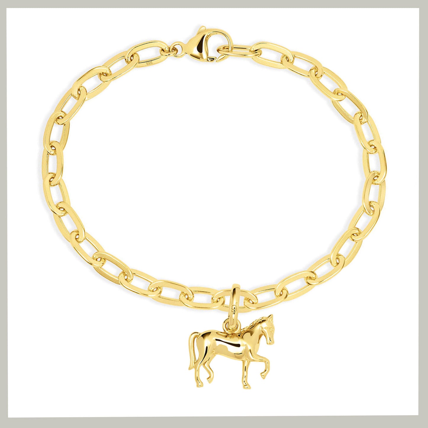 A gold chain bracelet with a dressage horse charm, displayed on a clean white background.