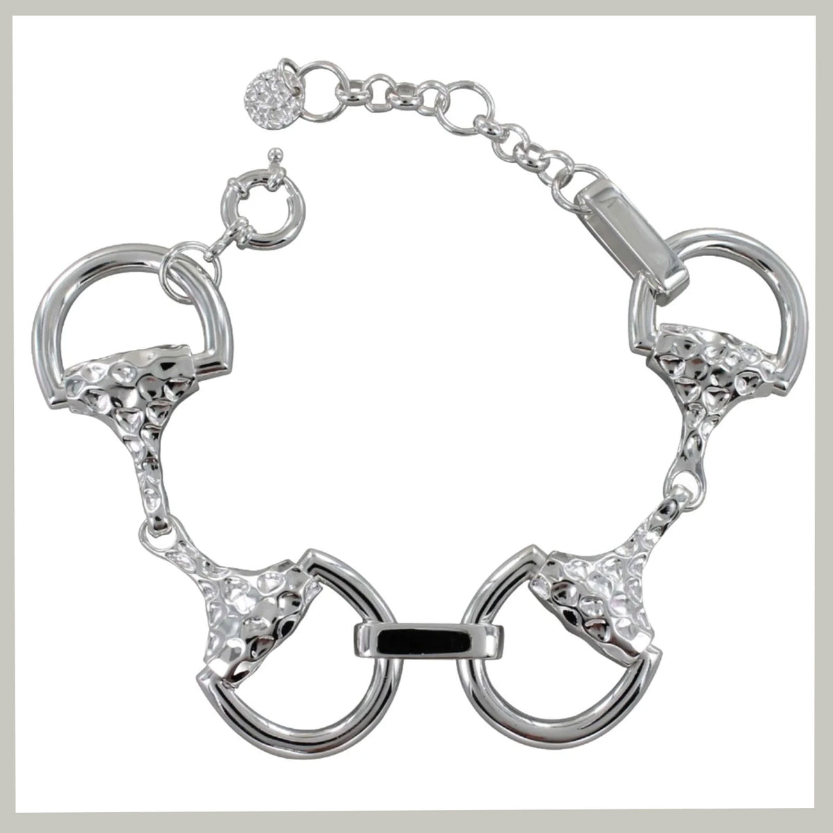 A silver-tone bracelet featuring horsebit-inspired rings with textured details and clear rhinestone accents, shown on a plain white background.