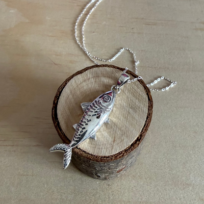 mackerel necklace on piece of wood