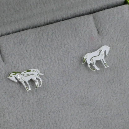 mare and foal earrings on grey cloth background